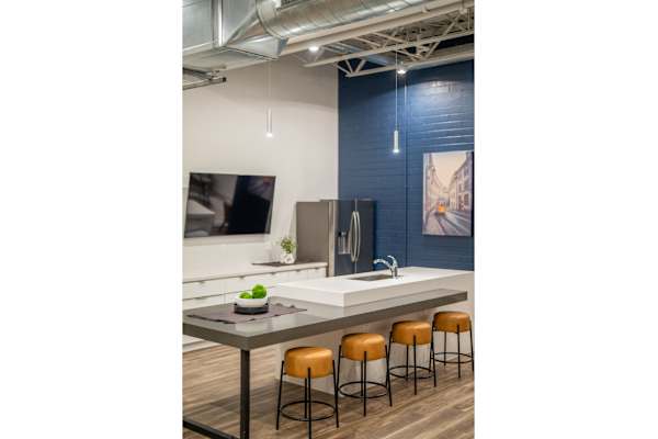 A kitchen with a table and chairs.
